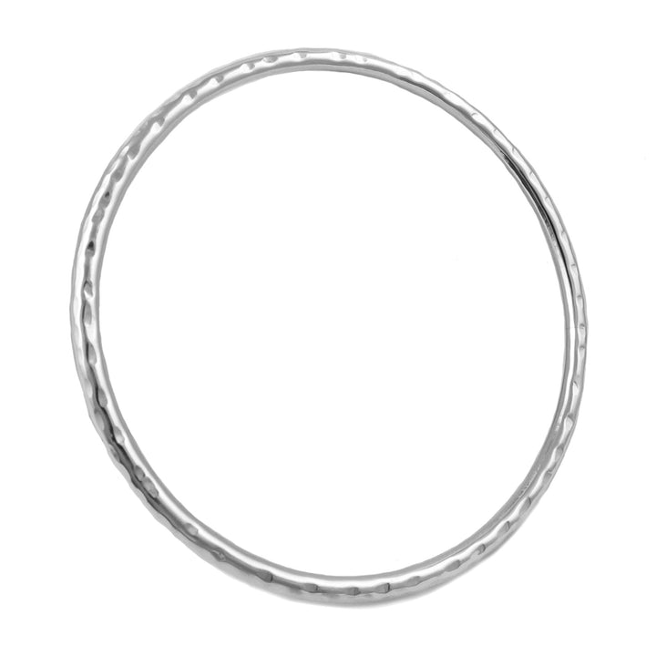 A large circle tube bangle in sterling silver with a hammered finish on a white background.
