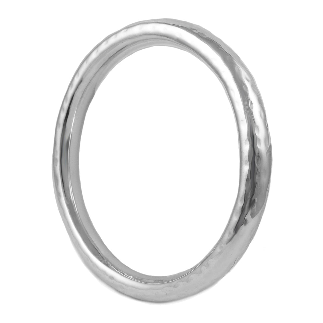 A large hallmarked silver hammered tube circle bangle with a reflective silver finish