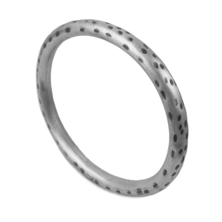 A 925 sterling silver oval bangle with animal print pattern, featuring black oxidised spots on a brushed finish.