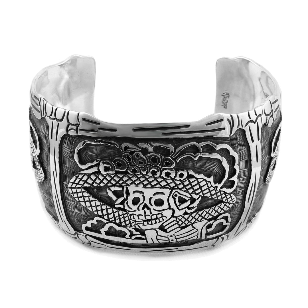 A large sterling silver bracelet cuff with day of the dead Catrina and bones design.