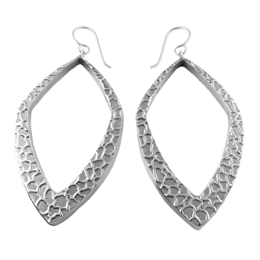 Large three-dimensional angled hoops in sterling silver with a raised relief pattern on a white background.