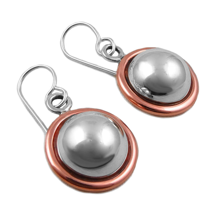 A pair of sterling silver and copper drop earrings with a bead design, presented against a white background.