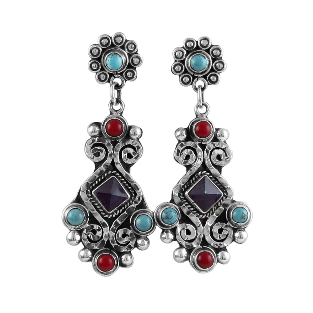 A pair of sterling silver dangle earrings with red and turquoise inlays, featuring amethyst gemstones and a blackened niello finish.