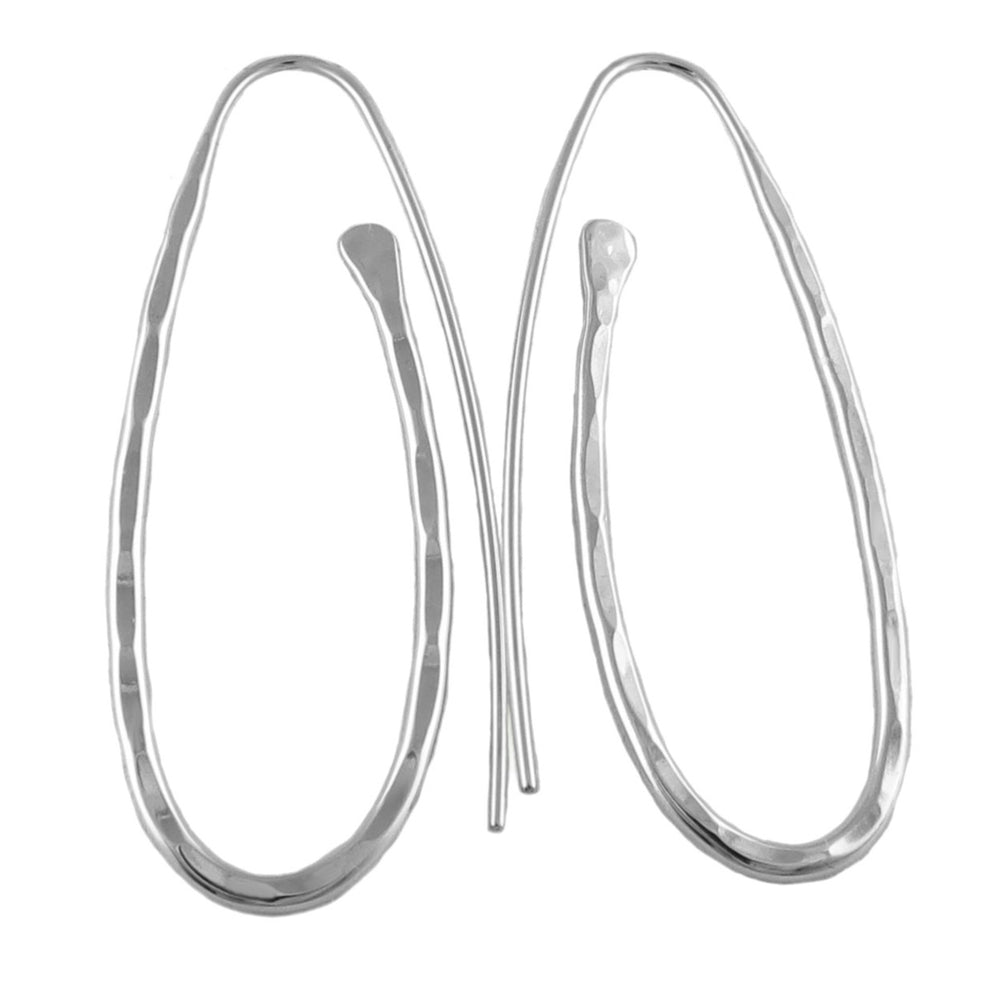 A pair of long oval silver threader earrings with a hand-hammered finish, showing light reflection on the surface.