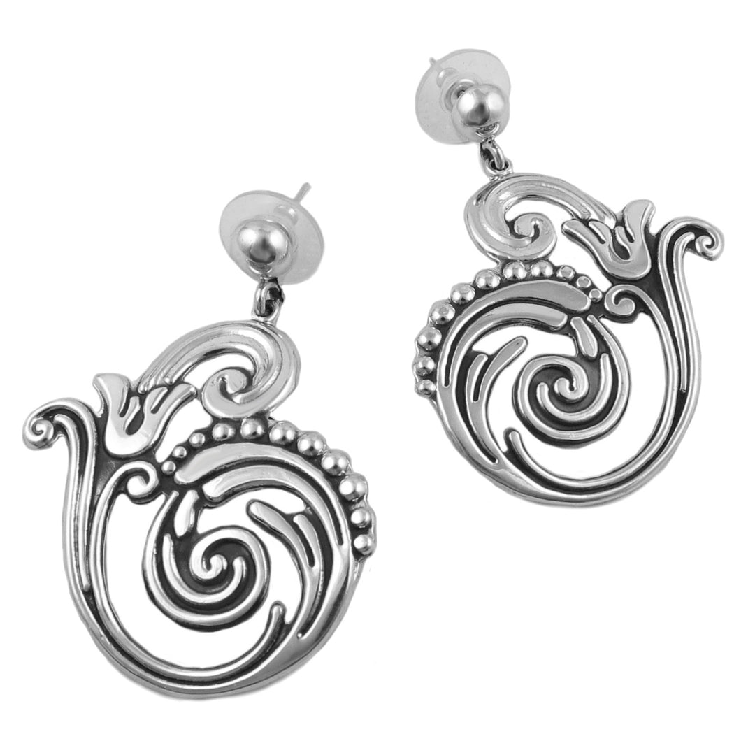 A pair of sterling silver hoop earrings with vine and flower designs, featuring blackened niello accents.