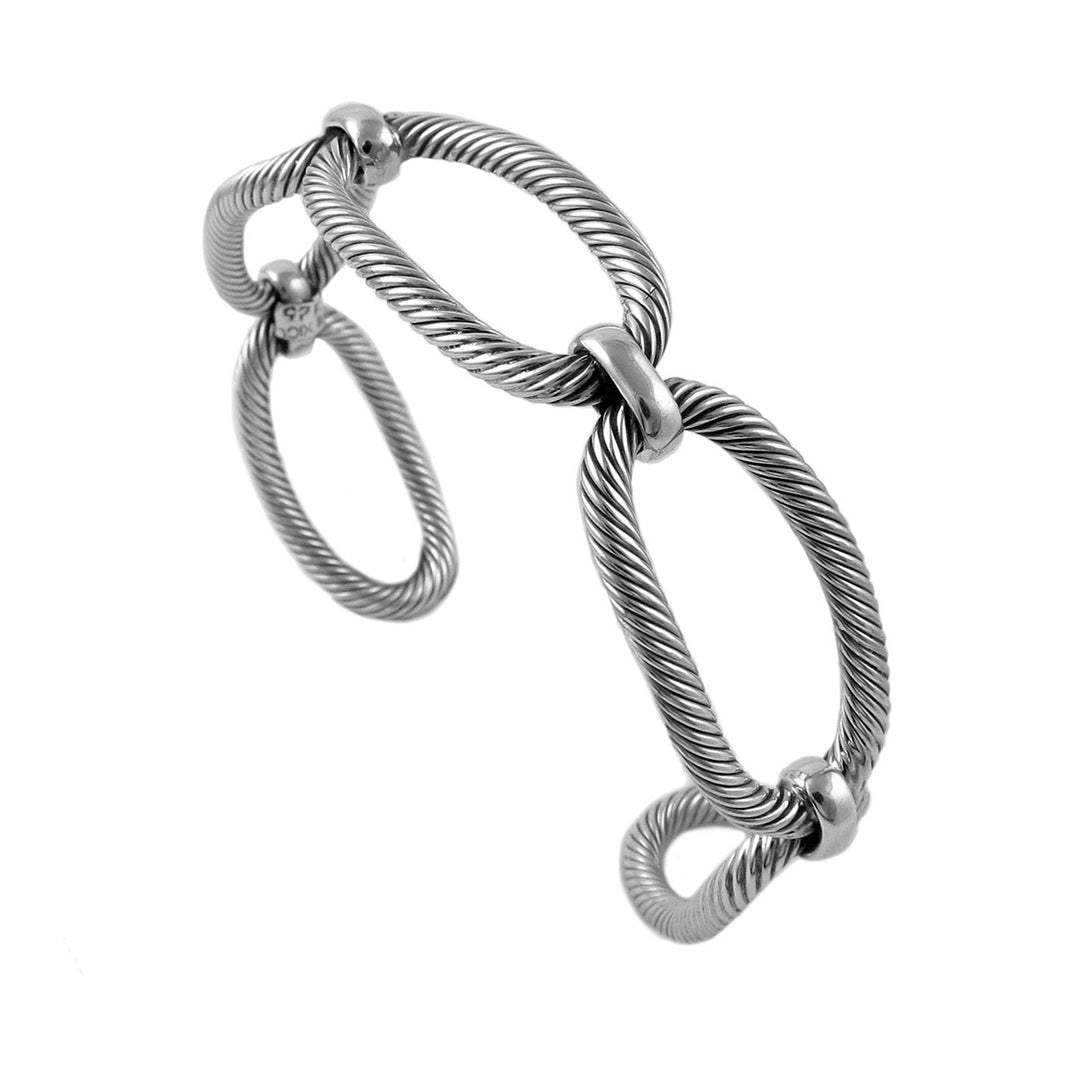 A sterling silver bracelet cuff with a rigid chain link design, showing an overlapping pattern typical of such jewelry pieces.