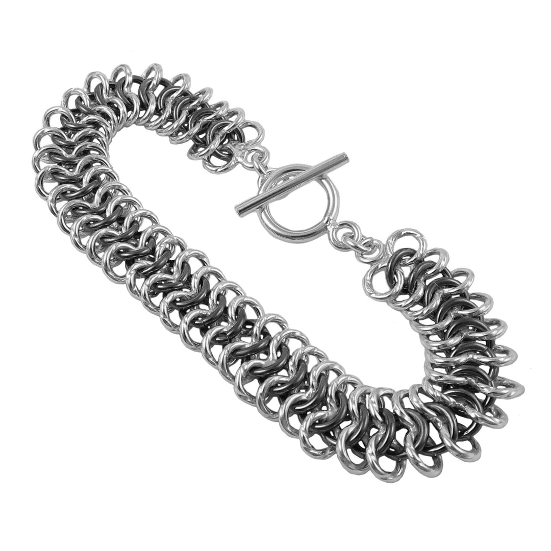 A sterling silver flat cable link chain bracelet with blackened rings.
