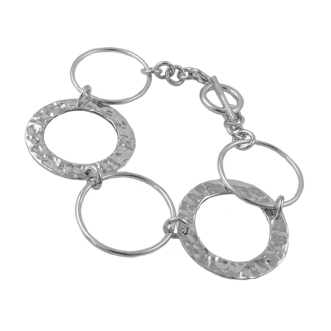 A silver infinity chain bracelet with wide hammered circles and slim polished links, fastened with a T-bar toggle clasp.