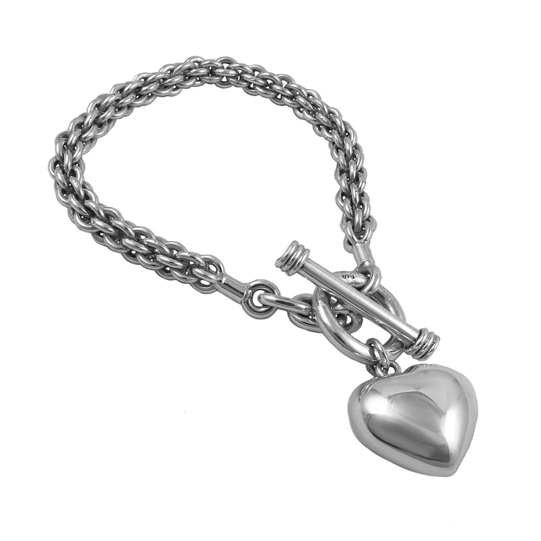 A chunky silver bracelet with a puffed heart chain design and a large toggle clasp.