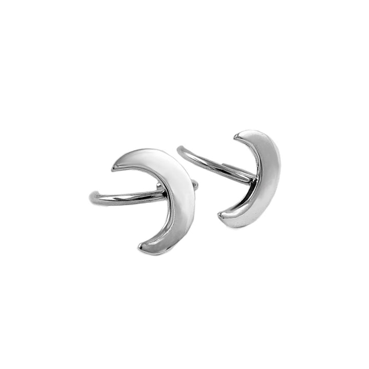 Sterling silver crescent moon ear cuff earrings on a white background.