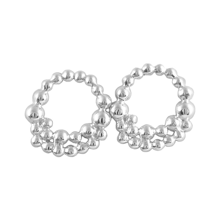 A pair of silver hoop earrings with a bubble design.