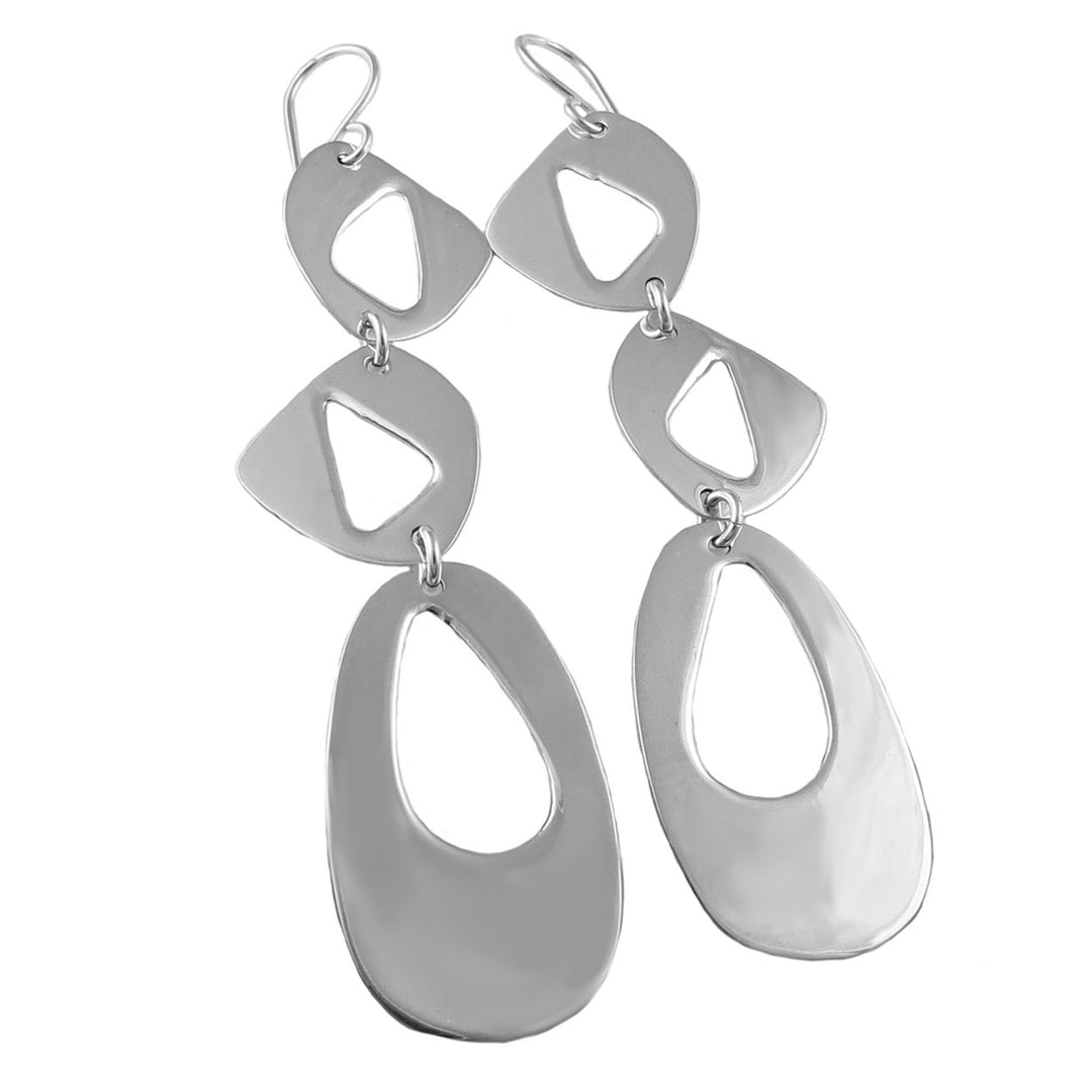 A pair of sterling silver geometric drop earrings with asymmetrical cut-away shapes, crafted in a Taxco style.
