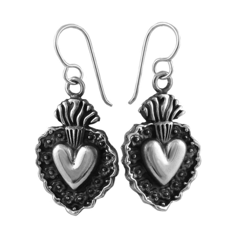 Sterling silver flsaming heart earrings on a white background