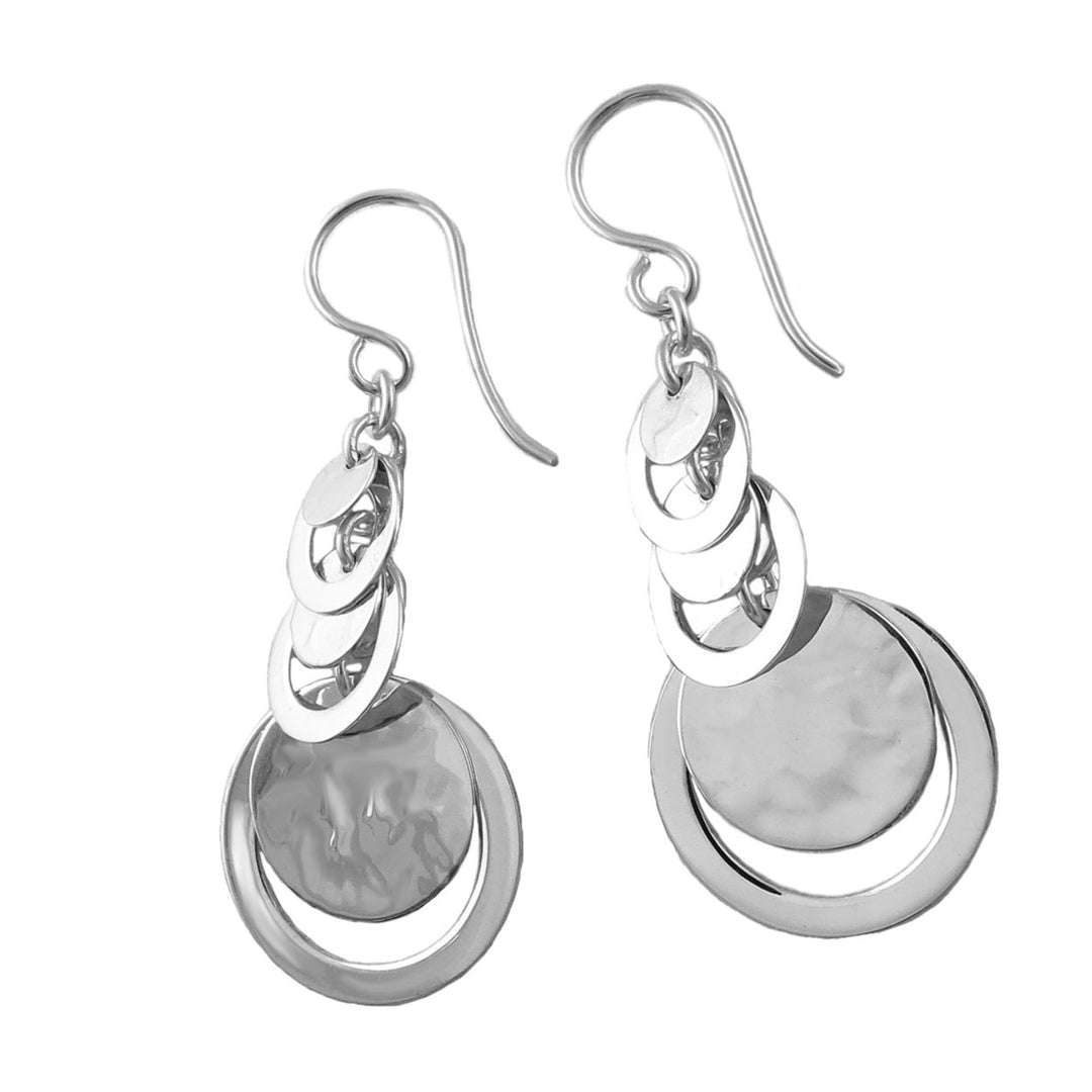 Pair of silver earrings with circular dangling drops on a white background