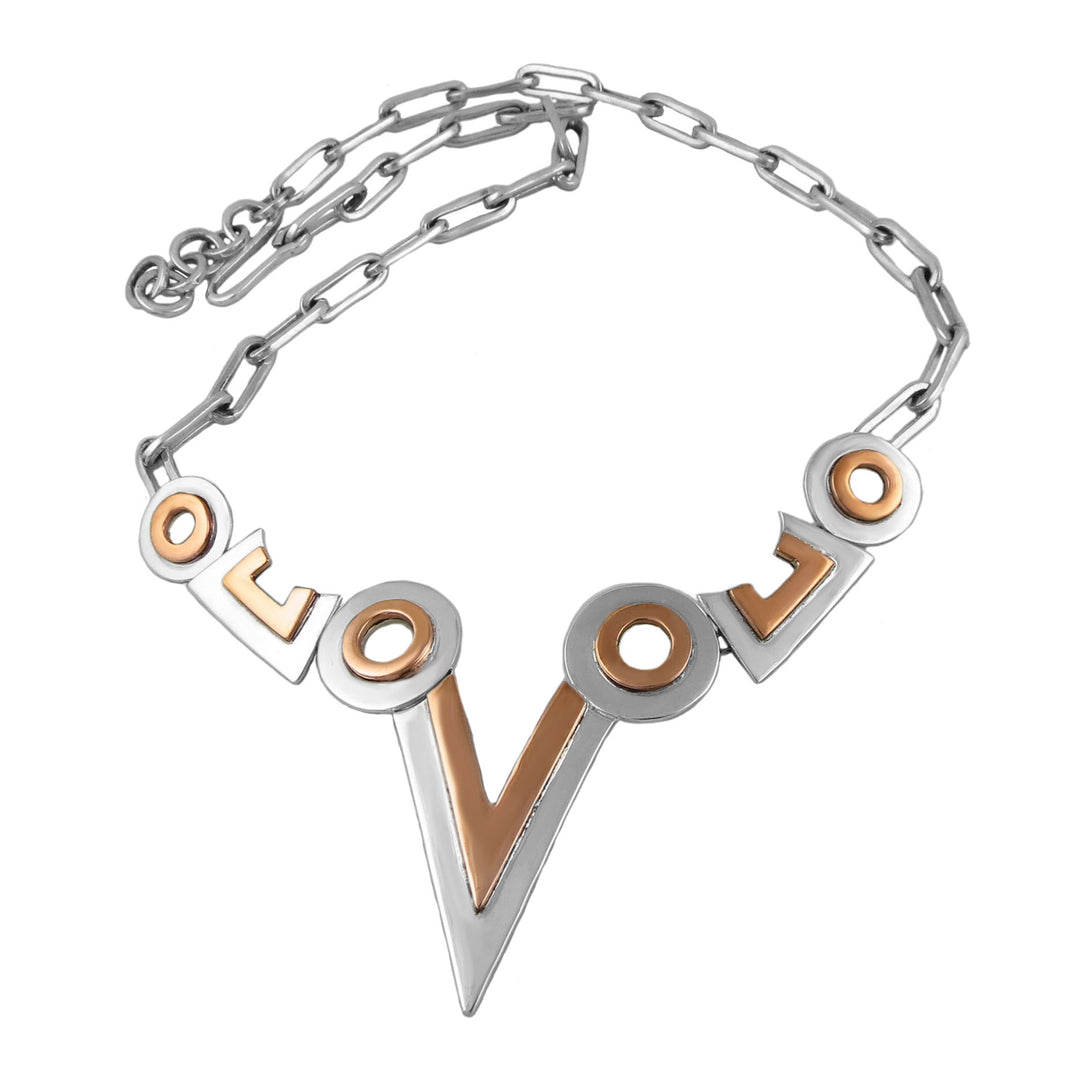 A sterling silver necklace with mixed metal accents, featuring a bold geometric design with silver and copper colors, and an adjustable chain.