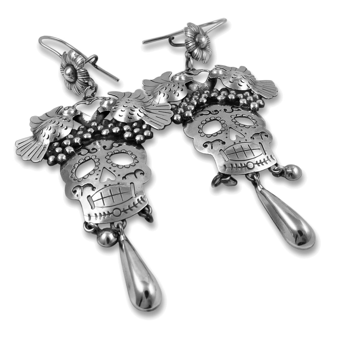 Day of the dead statement drop earrings on a white background.