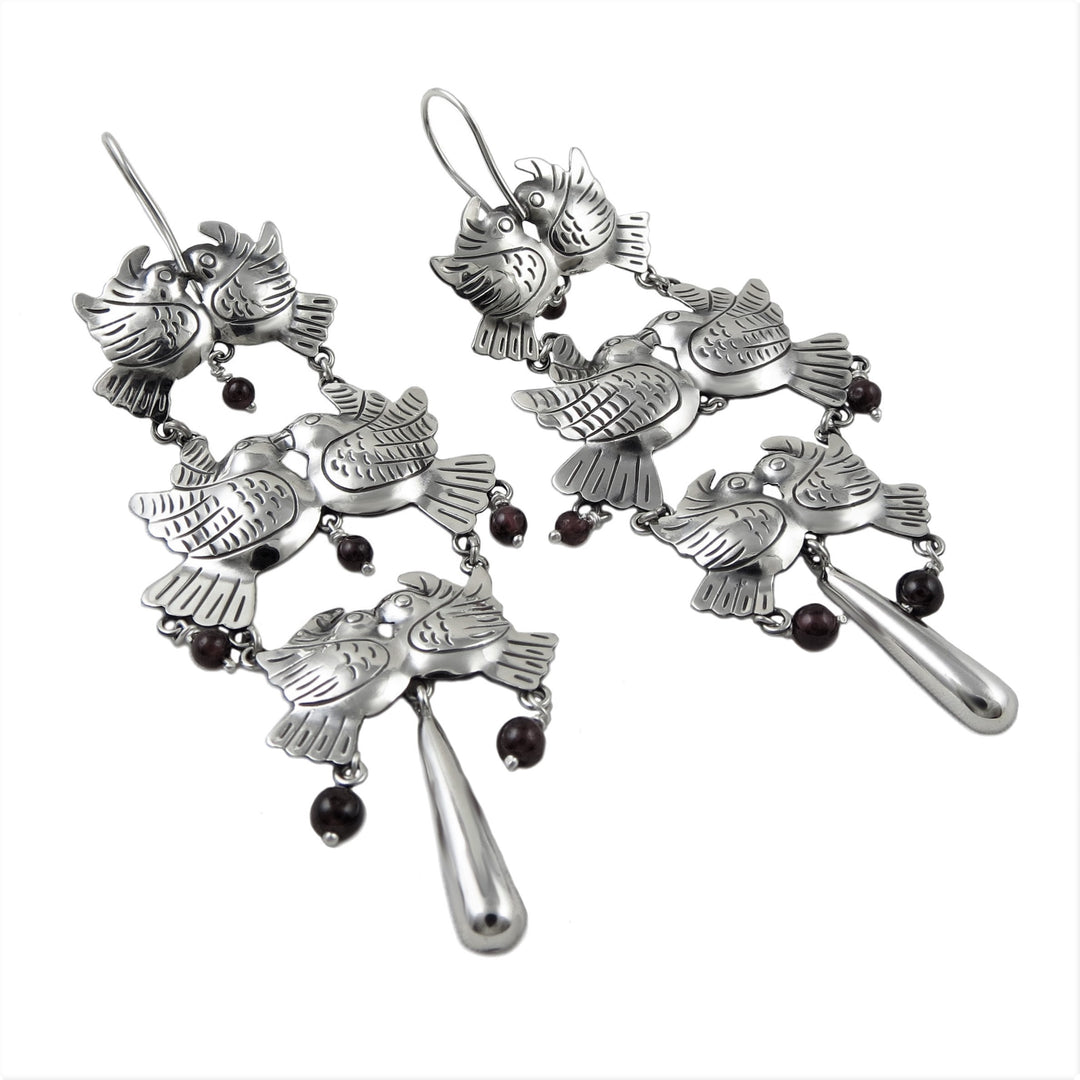 Long silvr and gemstone lovebird chandelier earrings on a white background