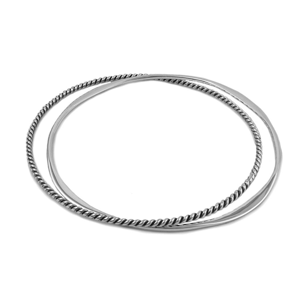 Double circle bangle in 925 silver featuring a polished circle and a twissted rope design circle.