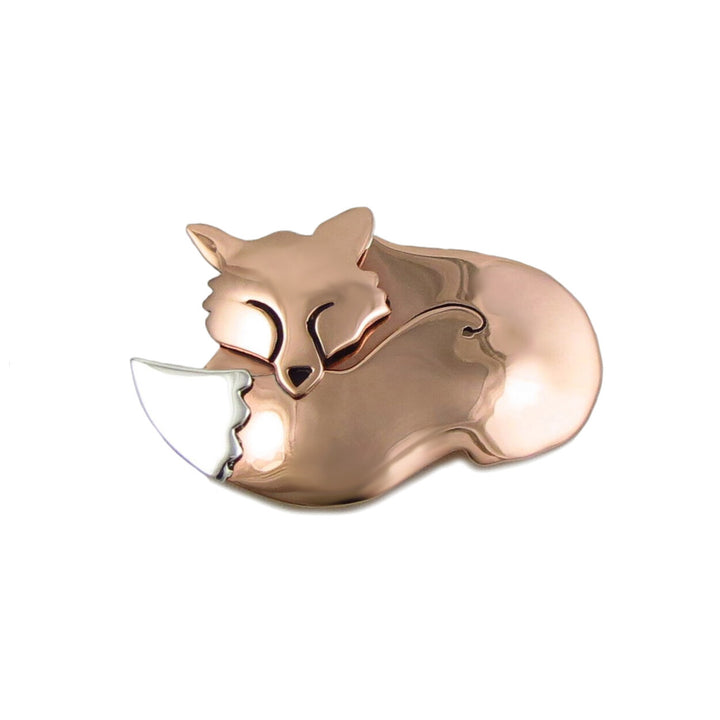 A brooch in the shape of a fox, with copper metal and silver accents.