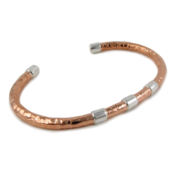 A copper bracelet with hammered texture and 925 silver accents, presented in a gift box.
