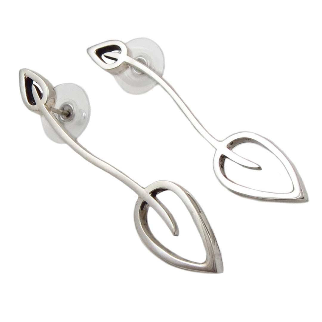 A pair of long statement sterling silver leaf earrings with curved stems and post fasteners.