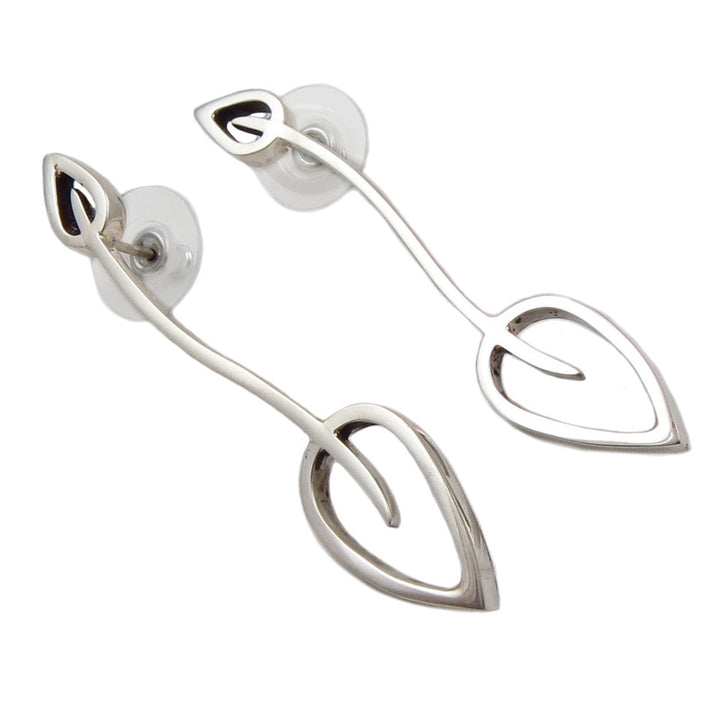 A pair of long statement sterling silver leaf earrings with curved stems and post fasteners.