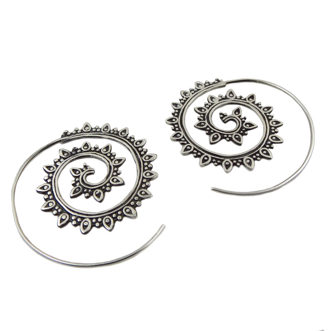 A pair of two-tone spiral threader earrings with a polished and blackened antiqued raised pattern on a silver-colored band.