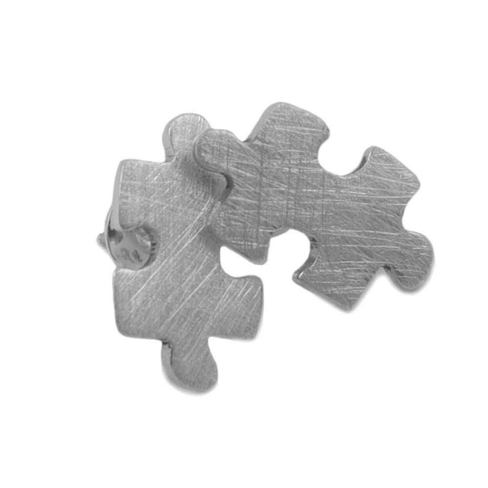 Brushed silver earrings in the shape of jigsaw pieces on a white backround