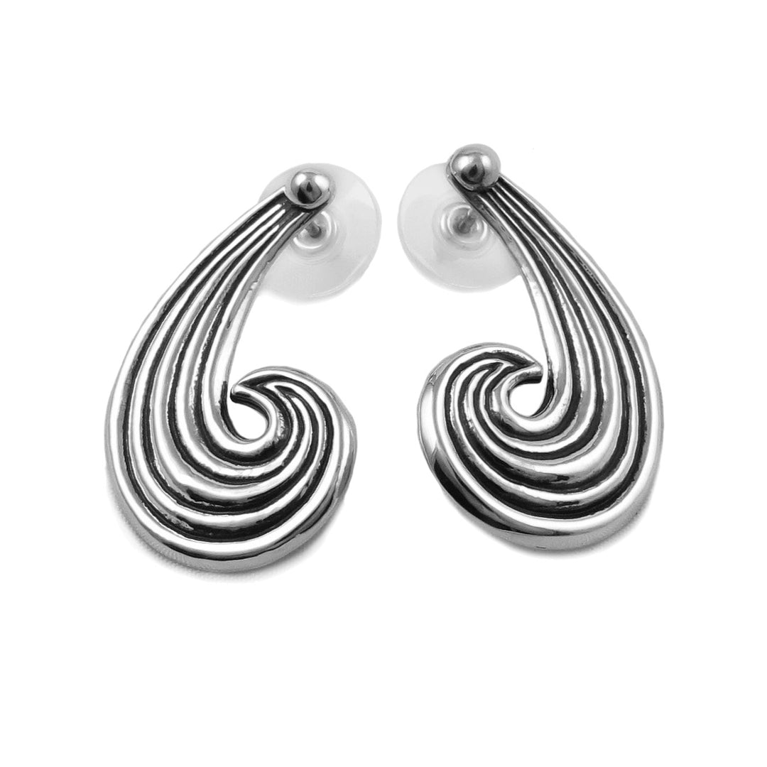 Long Maria Belen Nilson handmade earrings in the shape of waves on a white background.