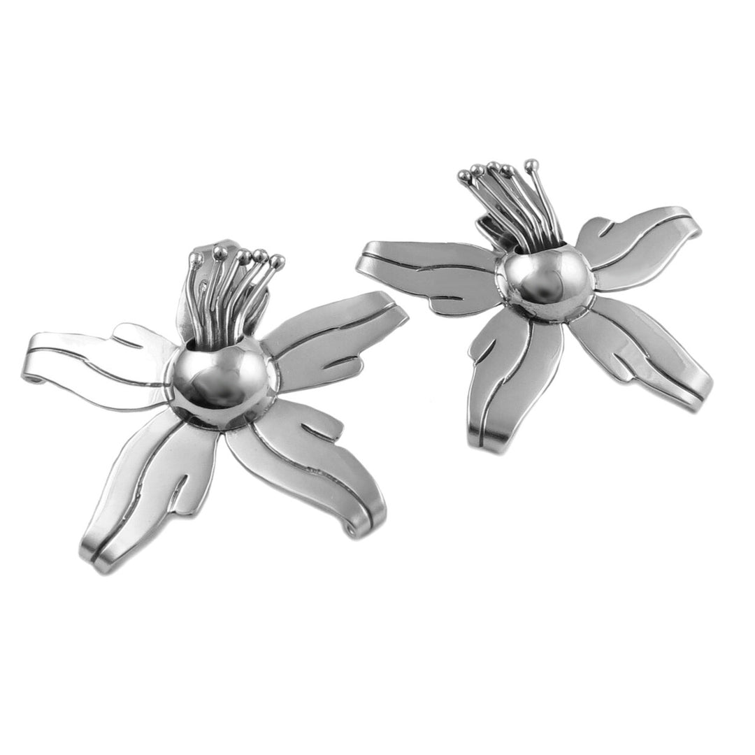 Sterling silver orchid earrings on a white background.
