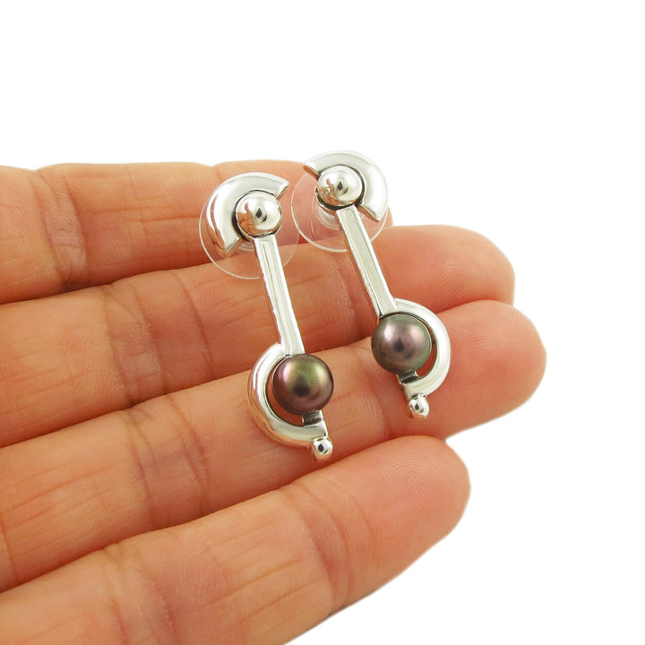 Long drop silver earrings with purple freshwater pearl earrings.