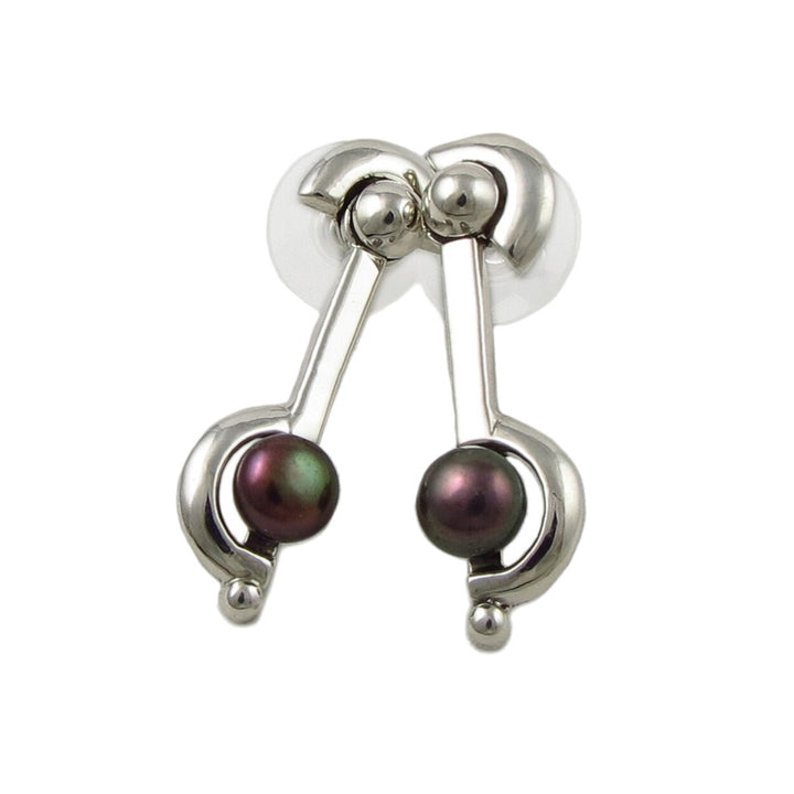 A pair of silver Freshwater Cultured Pearl Earrings with dark purple and blue pearls, designed by Maria Belen Nilson.