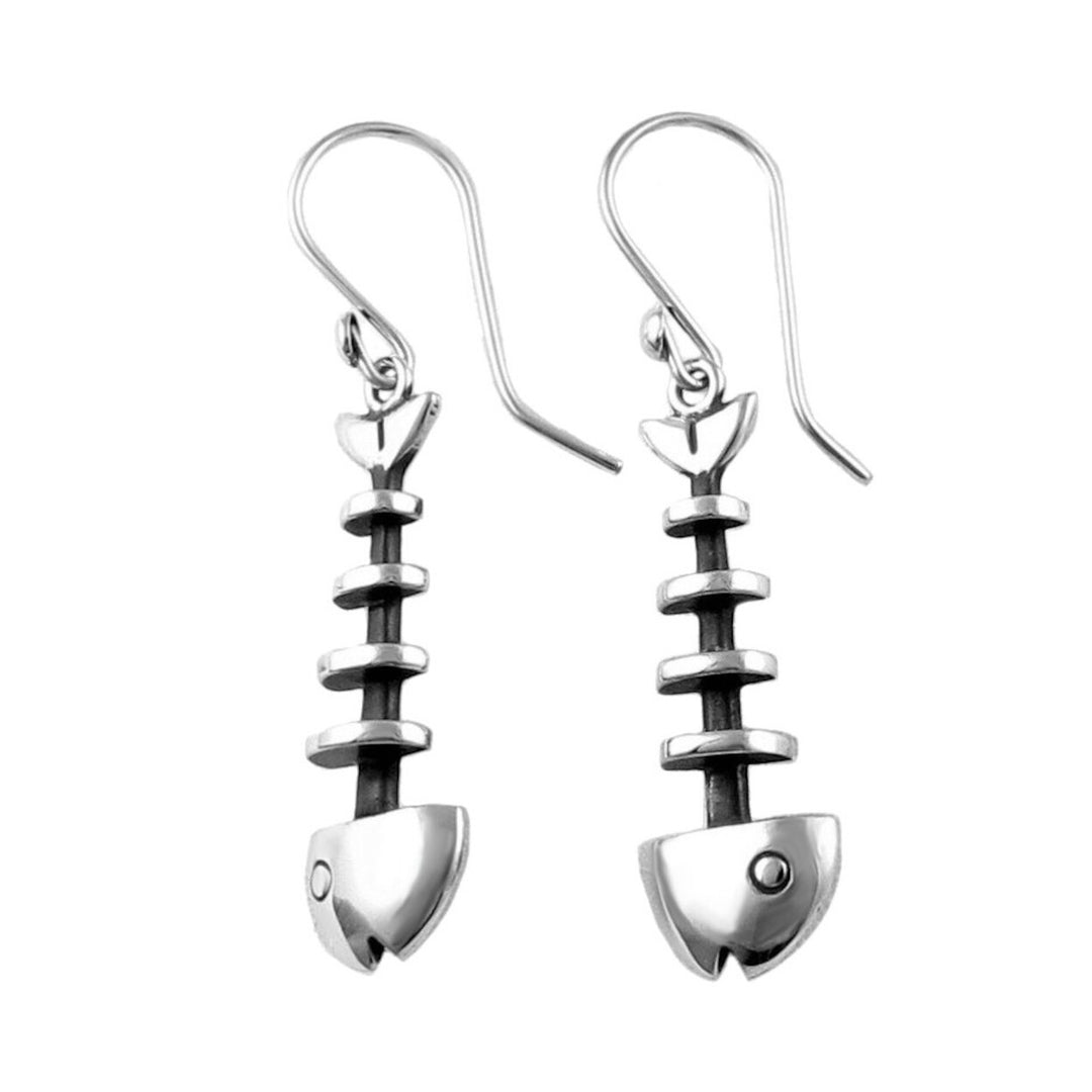 Long dangling 925 silver fish skeleton earrings on a white baxkground.
