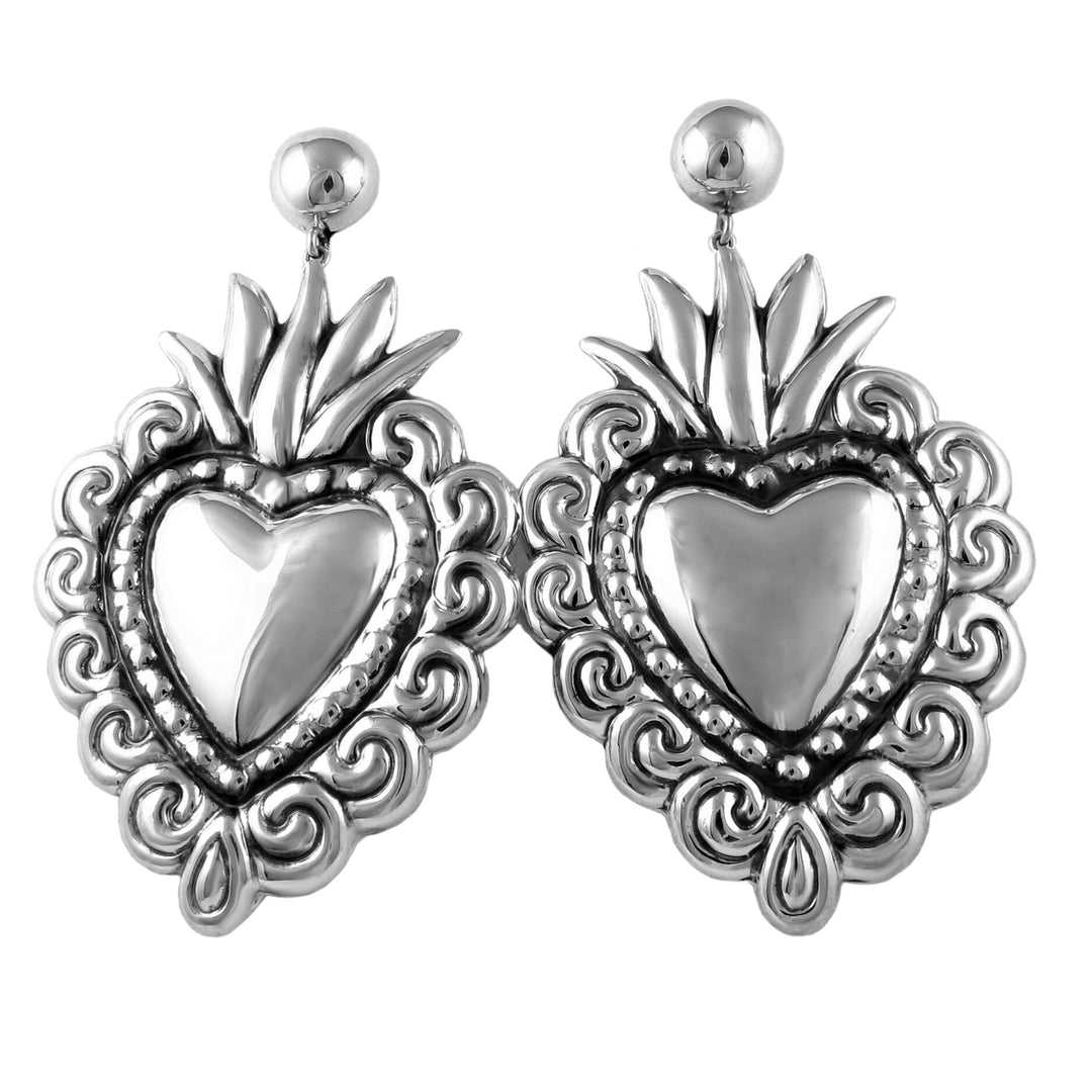 A pair of Maria Belen Nilson sterling silver chandelier earrings with a heart design, featuring a mirror-like polished finish.