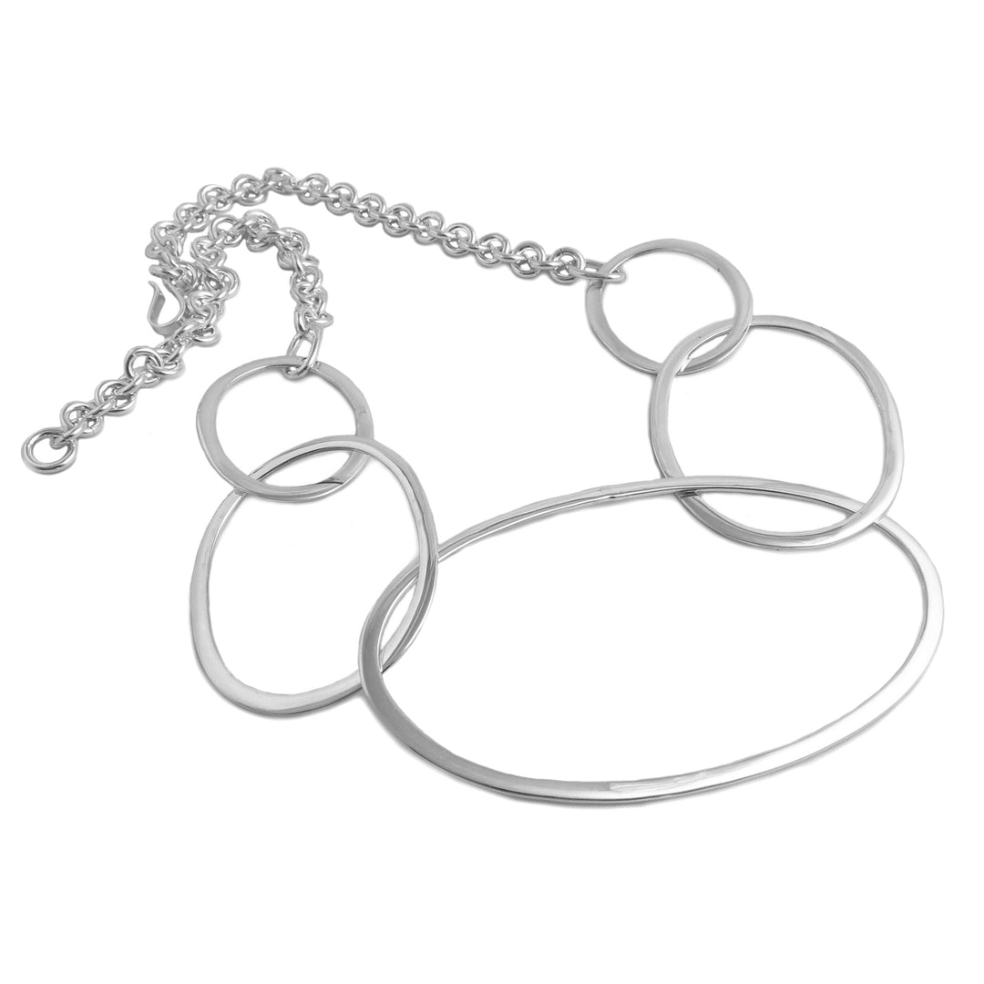 A statement chain necklace in sterling silver on a white background.