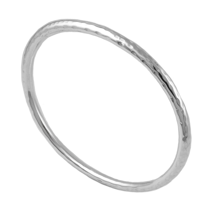 Oval hammered silver tube bangle on a white background
