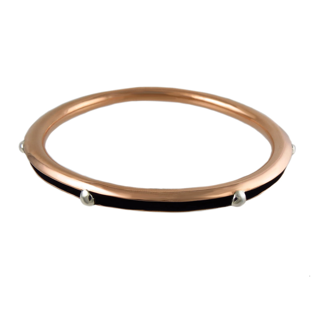 Mixed metal copper and silver bangle for women on a white background.