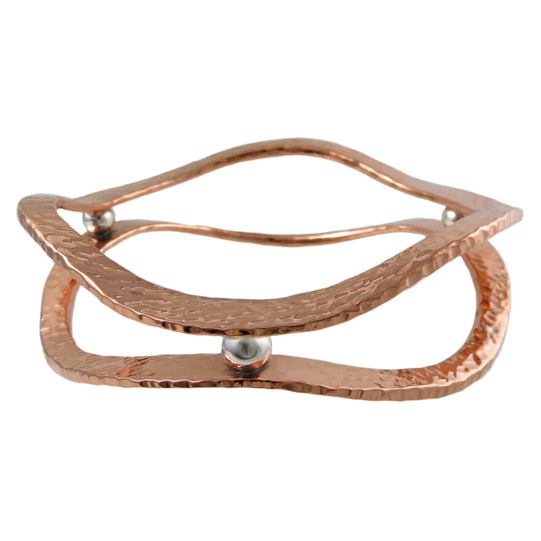Large double stack hammered copper and 925 silver designer handmade bangle on a white background