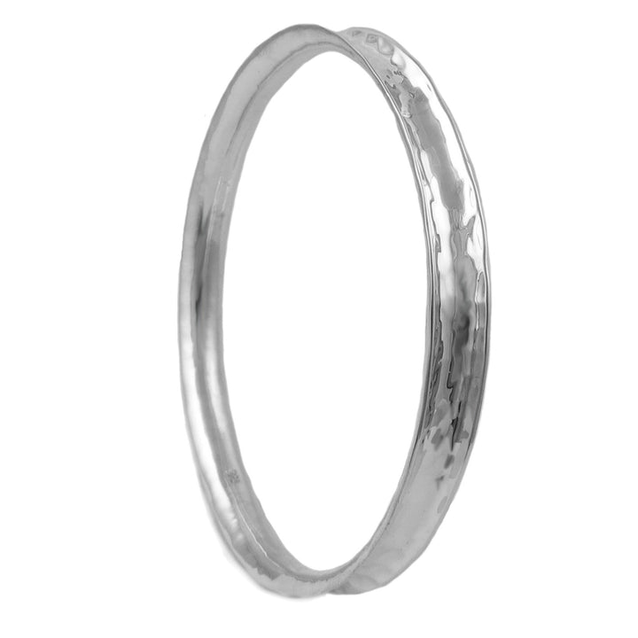 A large UK hallmarked 925 sterling silver circle bangle with a hammered finish on a white background