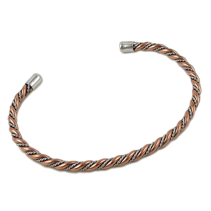 Large twisted copper and 925 silver rope bracelet cuff on a white background