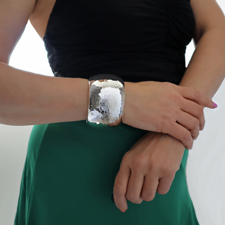 Person wearing a large over-sized bracelet cuff
