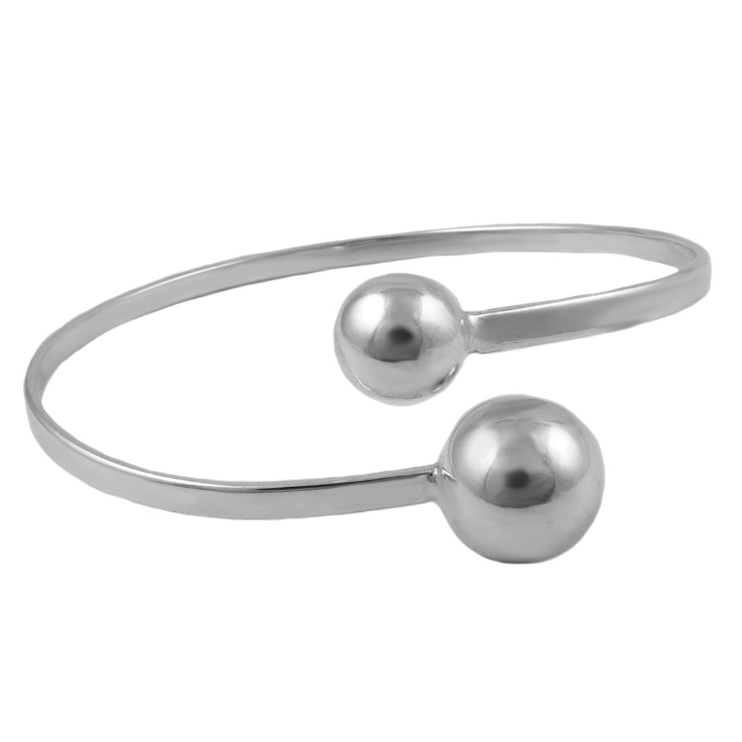 Silver bangle with two spherical ball bead ends on a white background