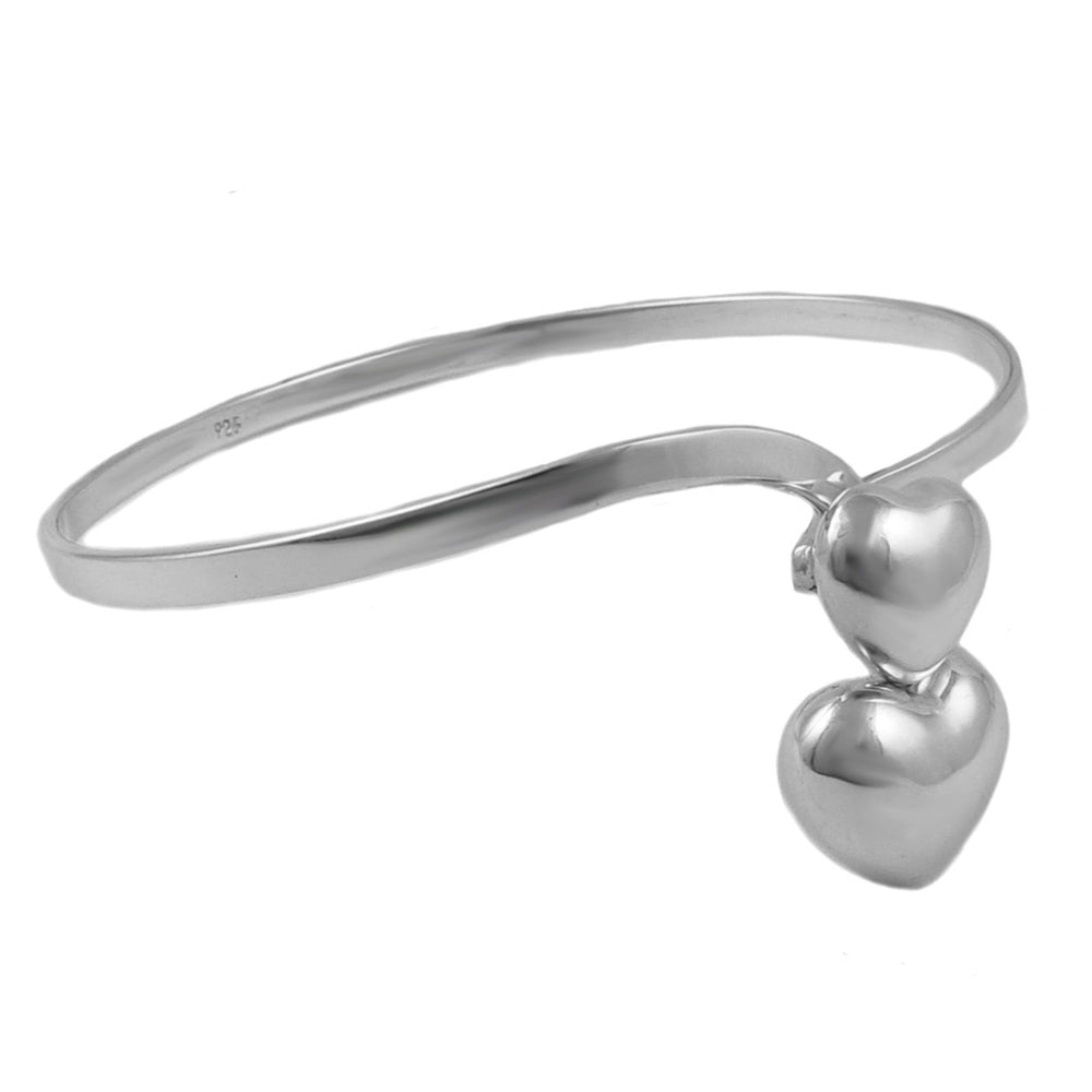 Silver bangle with two heart-shaped charms on a white background