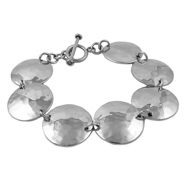 Silver bracelet with round links with a hammered finish on a white background