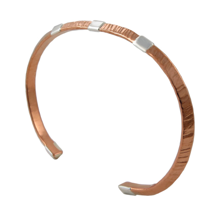 Copper and silver bracelet on a white background