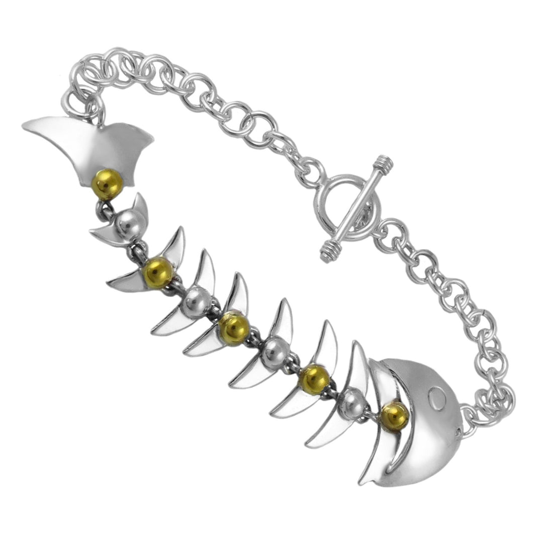 Statement sterling 925 silver Taxco fish skeleton bracelet with gold accents on a white background