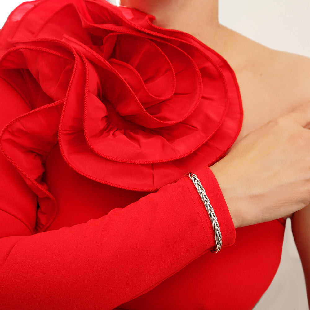 Woman in a red dress wearing a woven braided 925 sterling silver cuff bracelet