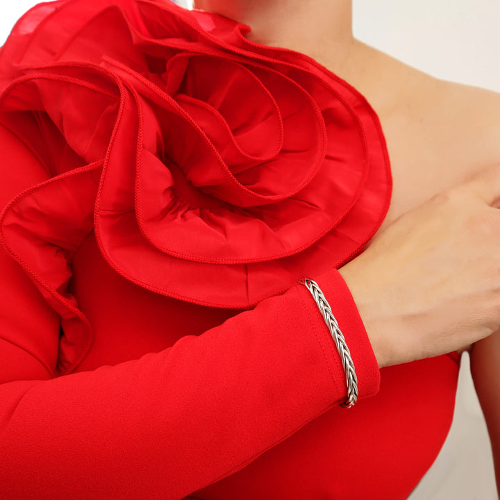 Woman in a red dress wearing a woven braided 925 sterling silver cuff bracelet