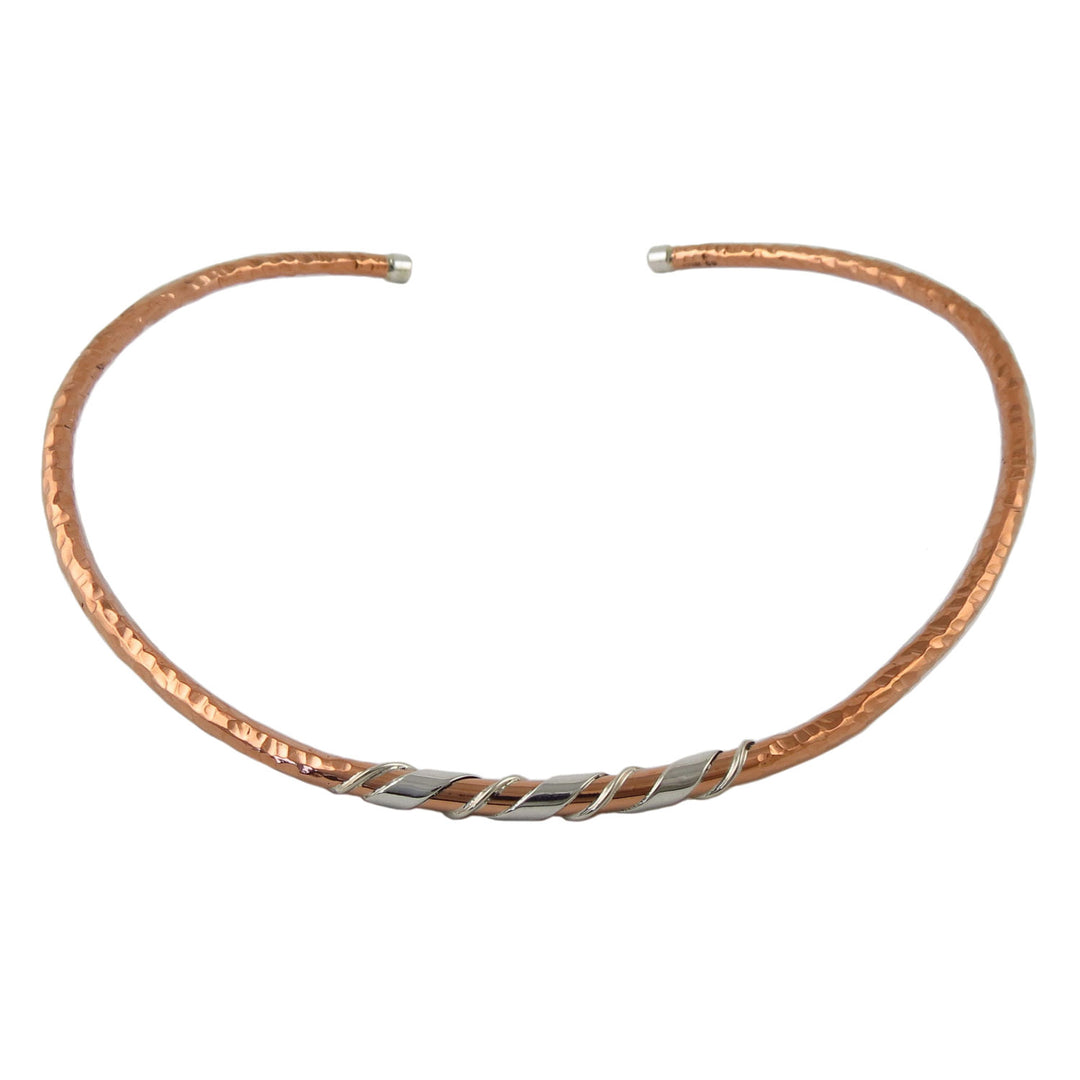 Stiff hammered copper and silver choker necklace on a white background