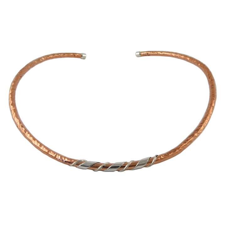 Stiff hammered copper and silver choker necklace on a white background